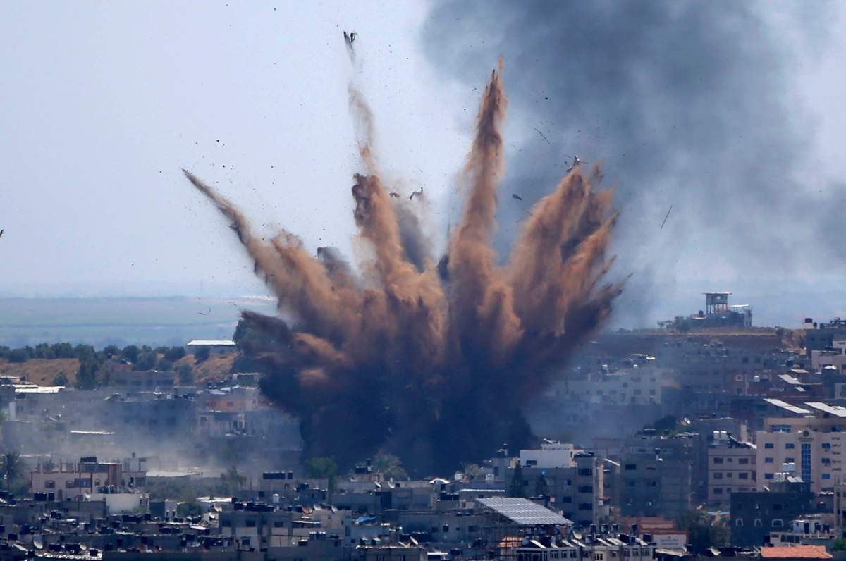 Smoke rises following Israeli airstrikes on a building in Gaza City, Thursday, May 13, 2021.
