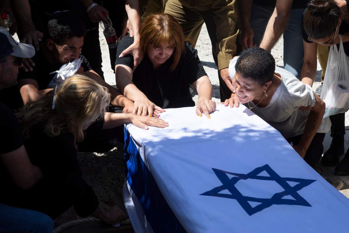 Relatives of Israeli soldier Omer Tabib, 21, mourn during his funeral at the cemetery in the northern Israeli town of Elyakim, Thursday, May 13, 2021. The Israeli army confirmed that Tabib was killed in an anti-tank missile attack near the Gaza Strip, the first Israeli military death in the fighting.