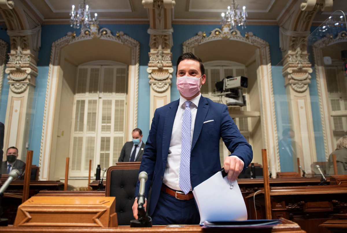 Quebec Justice Minister Simon Jolin-Barrette, responsible for French language, hold a copy of a legislation to modify the language law before presenting it, Thursday, May 13, 2021 at the legislature in Quebec City. 
