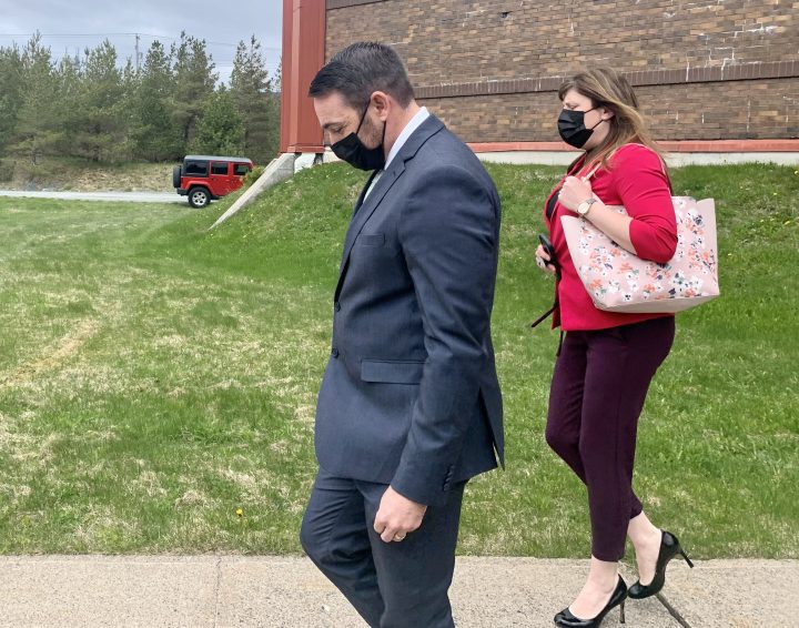 Royal Newfoundland Constabulary Const. Carl Douglas Snelgrove keeps his head down as he leaves court on Thursday, May 13, 2021 in St.John's, after a jury was sequestered to determine whether or not he is guilty of sexually assaulting a 21-year-old woman while on duty in 2014. 