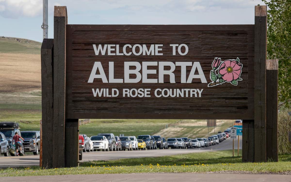 Southern Alberta residents line up to get shots of a COVID-19 vaccine from a Montana tribe in Carway, Alta., Tuesday, May 18, 2021.