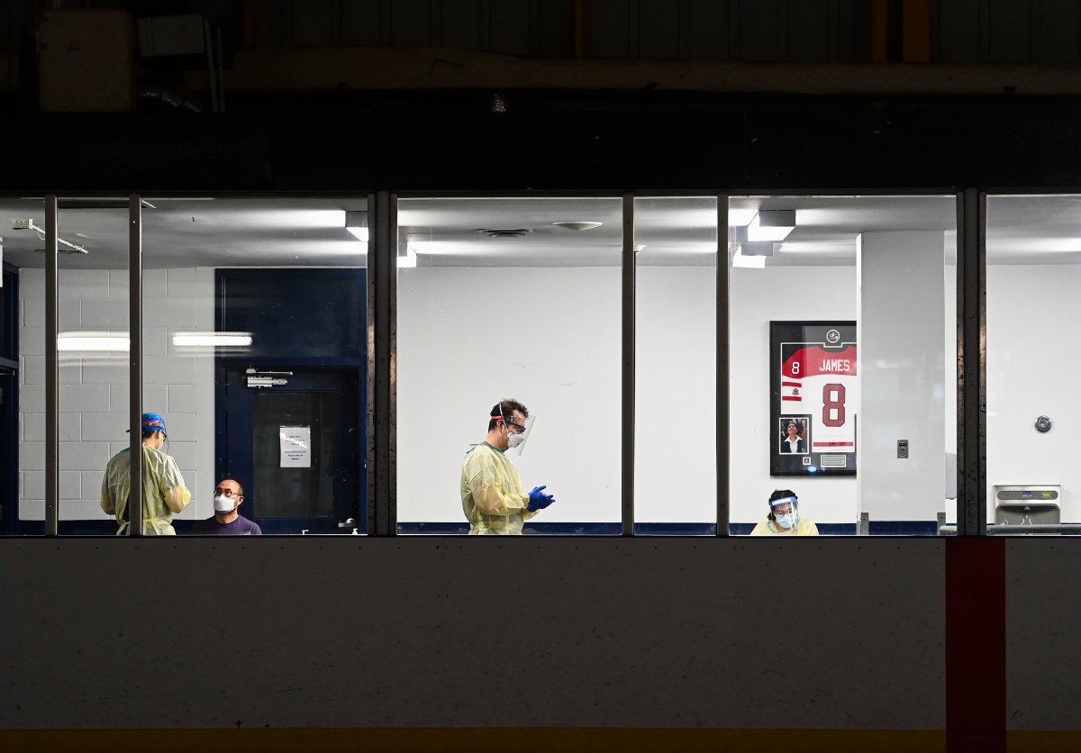 Health-care workers get ready to test a person at a pop-up COVID-19 assessment centre at the Angela James Arena during the COVID-19 pandemic in Toronto May 19, 2021. 