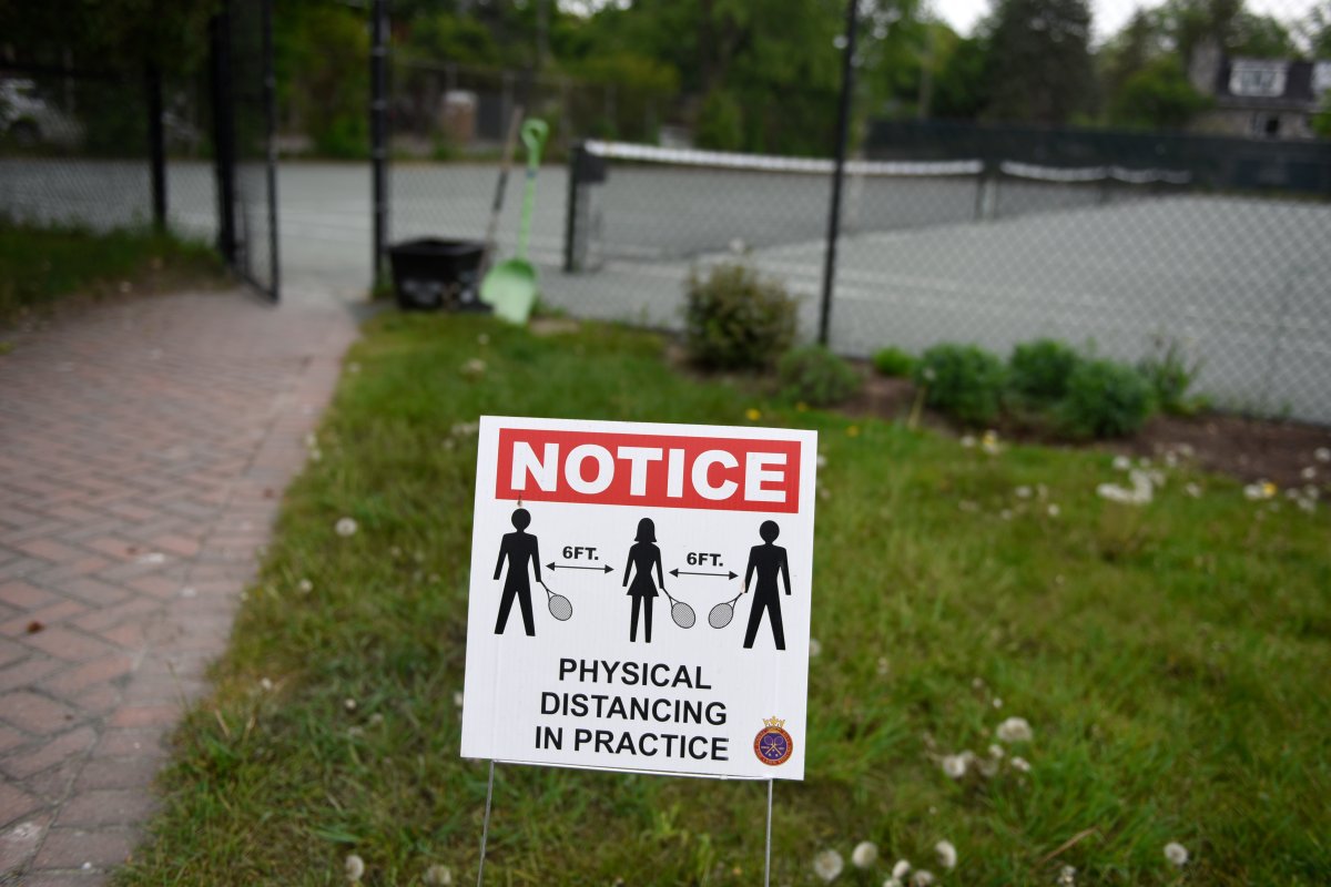A physical distancing notice is seen at the Ottawa Tennis and Lawn Bowling Club in Ottawa, Friday, May 21, 2021.