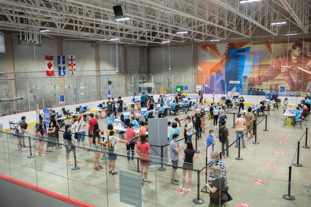 People are shown at the Bill Durnan Arena COVID-19 vaccination site in Montreal, Saturday, May 22, 2021. 