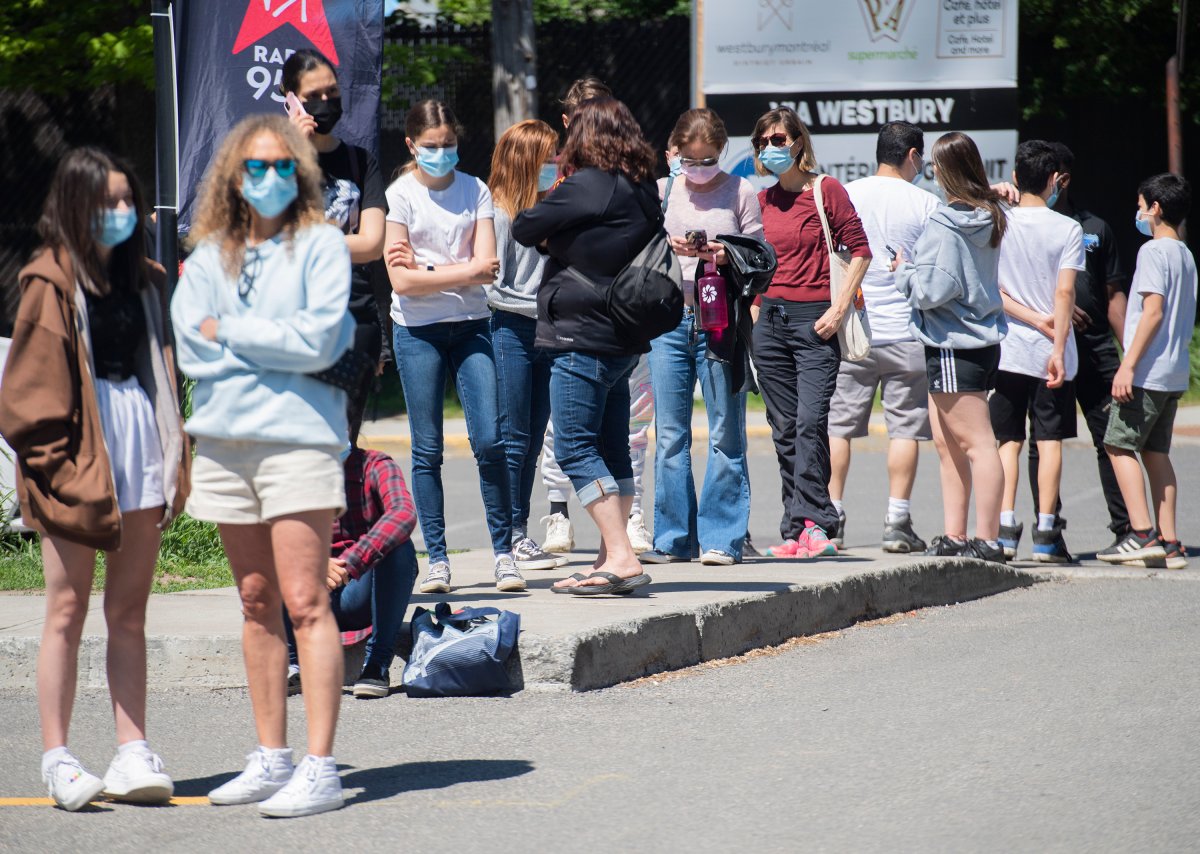 People wait in line to receive a COVID-19 vaccine shot at the Bill-Durnan COVID-19 vaccination site in Montreal, Monday, May 24, 2021, as the COVID-19 pandemic continues in Canada and around the world. 