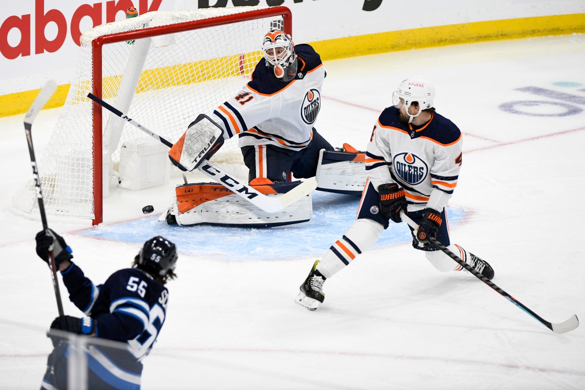 Winnipeg Jets' Mark Scheifele (55) scores on Edmonton Oilers goaltender Mike Smith (41) during first period NHL Stanley Cup playoff action in Winnipeg on Monday, May 24, 2021. THE CANADIAN PRESS/Fred Greenslade.