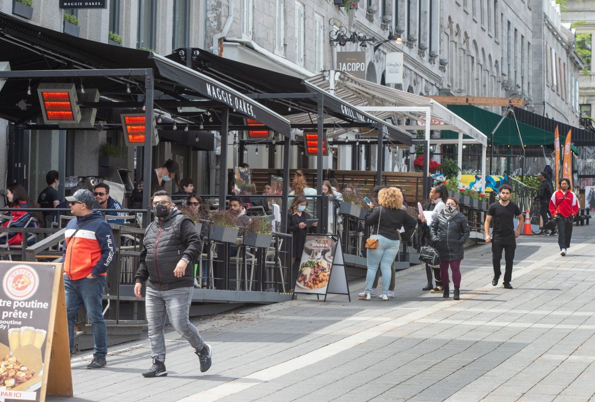 People enjoy restaurant patios as they re-open for the first time since last September in Montreal as Quebec begins easing its COVID-19 restrictions on Friday, May 28, 2021. 