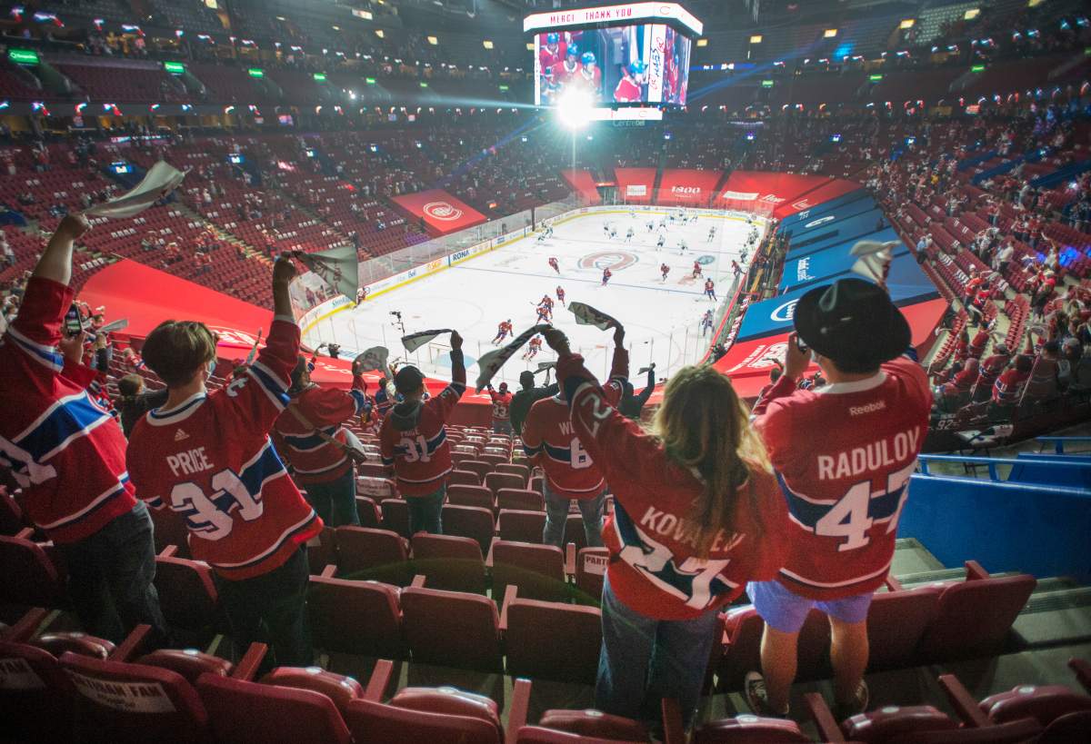 Fans watch the warm-up before Game 6 between the Toronto Maple Leafs and the Montreal Canadiens in NHL playoff hockey action Saturday, May 29, 2021 in Montreal. Quebec’s easing of COVID-19 restrictions will allow 2,500 fans to attend the game for the first time in fourteen months.