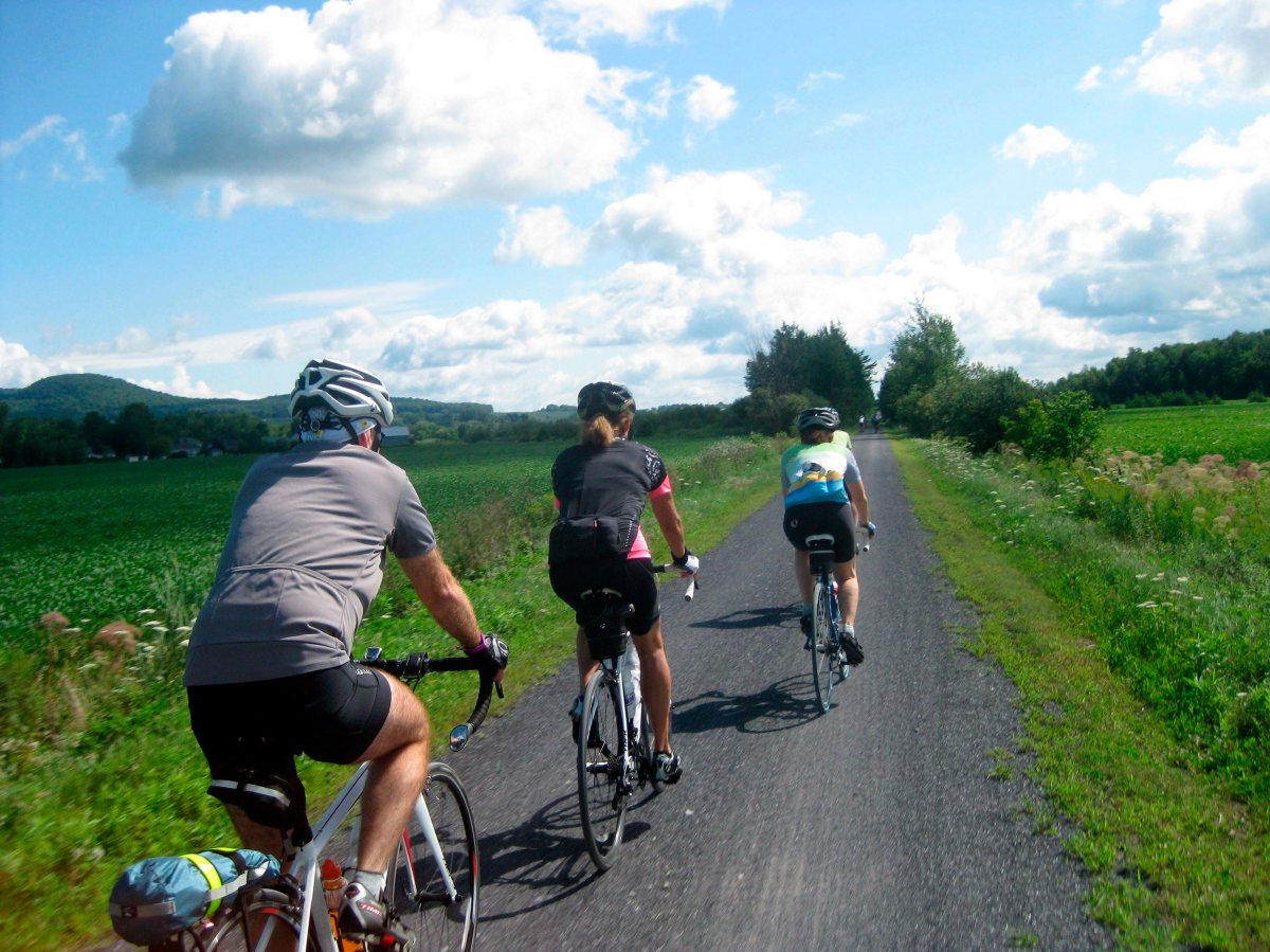 Cyclists on Velo Quebec's Grand Tour sweep along a trail in the Eastern Townships, Aug. 1, 2015. 