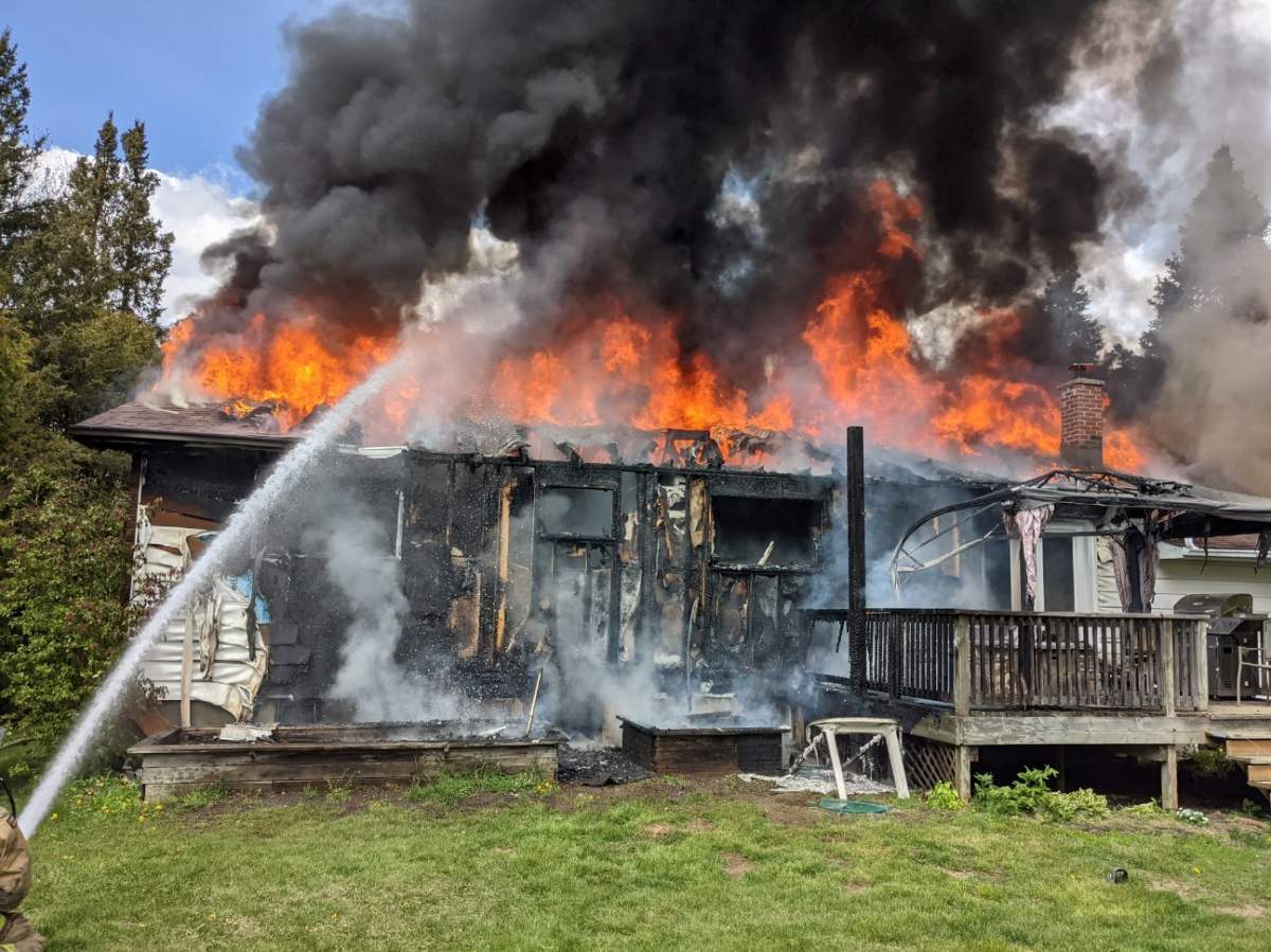 A home on Cedar Acres Drive in Greely was engulfed in flames Monday afternoon.