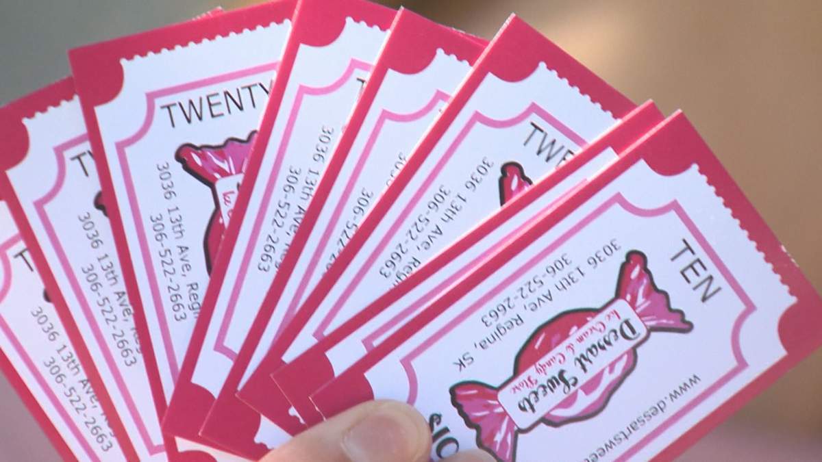 A Dessart Sweets customer shows the gift cards she bought in response to an encounter between a group of anti-maskers and store staff.