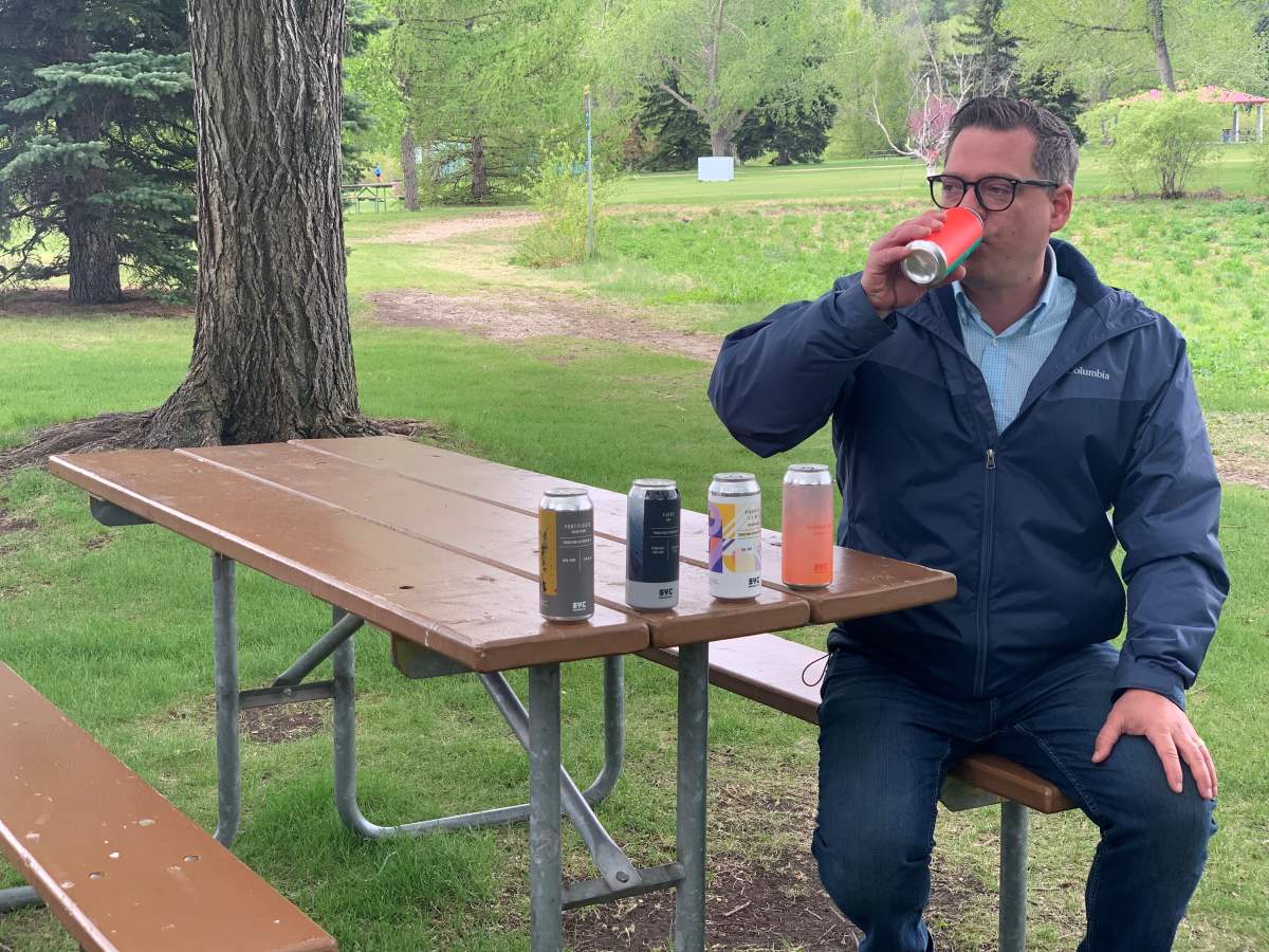 Edmonton city councillor Jon Dziadyk has a sip of beer to launch the city's alcohol consumption pilot project at designated areas in seven river valley parks, Friday, May 28, 2021.