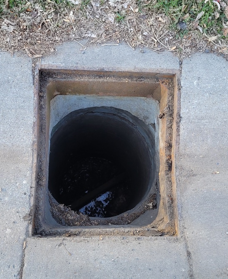 A catch basin that has had the cover removed.