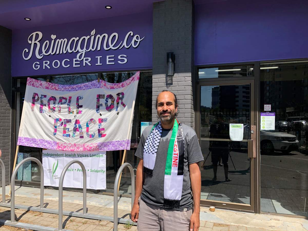 RICS president Heenal Rajani standing outside the non-profit's sister social enterprise Reimagine Co.