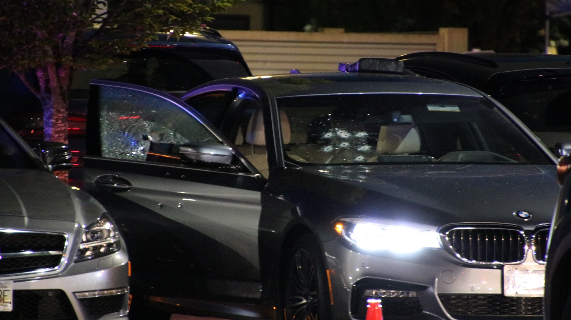 A vehicle riddled with bullets sits in the parking lot of a Cactus Club restaurant in Burnaby, B.C., where a shooting occurred on May 13, 2021.