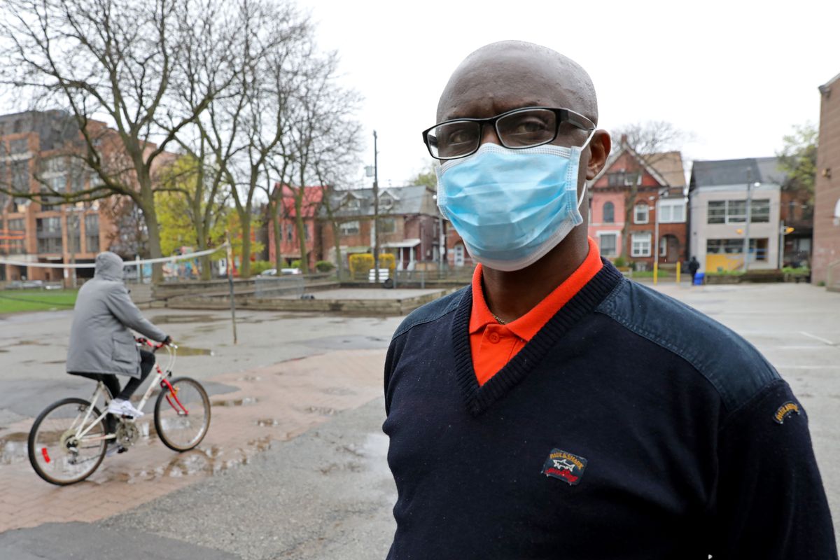 Apollinaire Nduwimana, a Burundian teacher and asylum-seeker who is awaiting a refugee application, poses outside a school near his lodging in Toronto, Ontario, April 29, 2021.