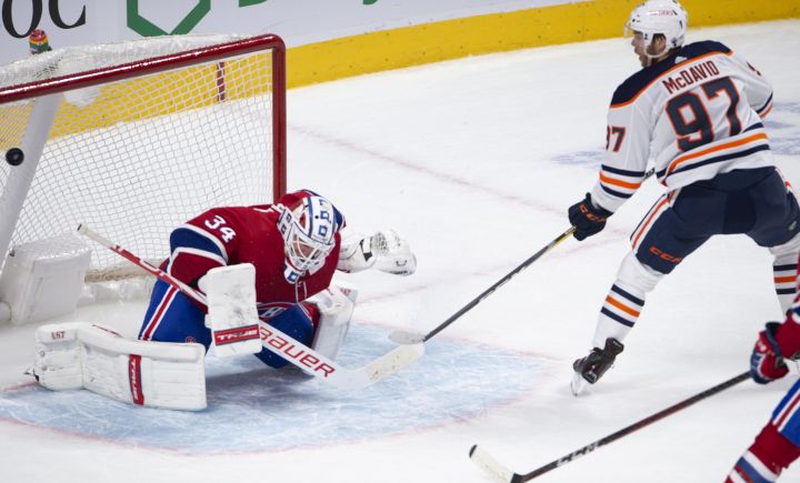 Edmonton Oilers’ Connor McDavid (97) scores the winning goal on Montreal Canadiens goaltender Jake Allen (34) during overtime NHL hockey action in Montreal, Monday, May 10, 2021.