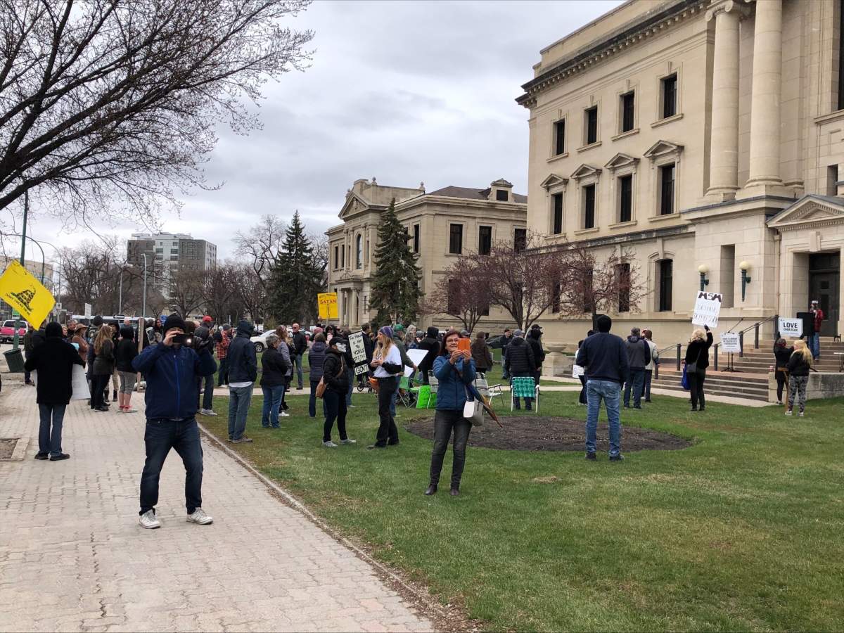 Protestors gather outside the provincial court building in Winnipeg  for an anti-restrictions rally.
