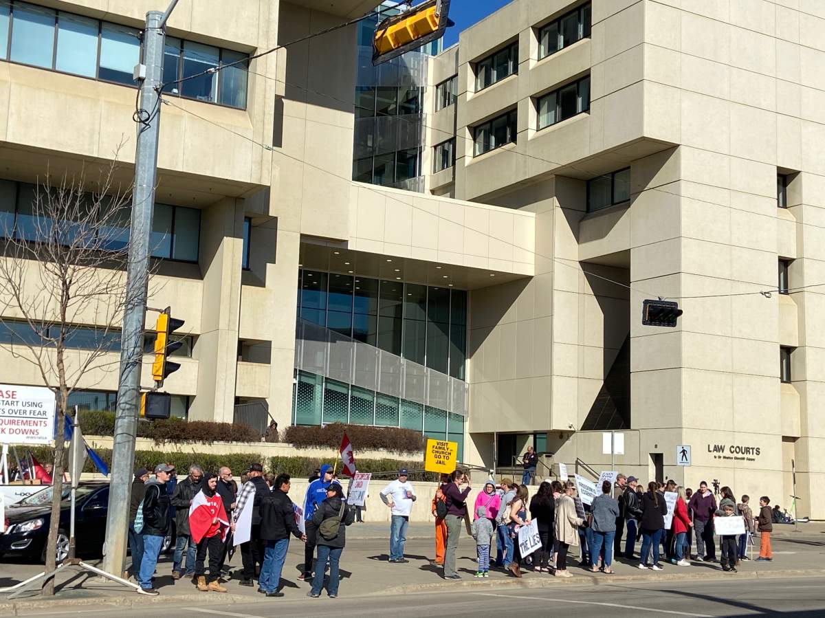 People rally outside the courthouse in Edmonton in support of pastor James Coates of GraceLife Church whose trial began Monday, May 3, 2021.