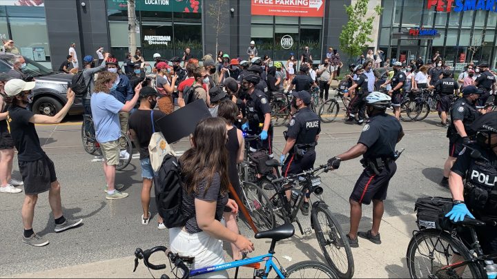 Police on scene as officials clear out a homeless encampment in Toronto on Wednesday.