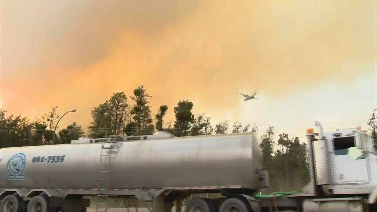 Ground and air teams battle a wildfire burning near the City of Prince Albert, Sask., on May 21, 2021.