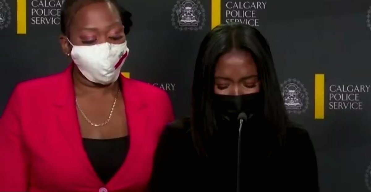 Tianna Hay is supported by her sister and recounts, through tears, the trauma of being spat on and called a racial slur by a stranger outside a Calgary store.