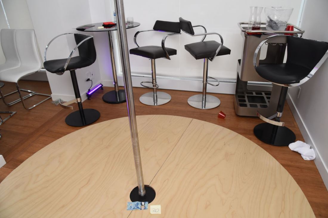 A stripper pole with a $5 bill at its base inside Mohammad Movassaghi’s penthouse on Jan. 31, 2021