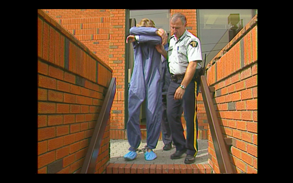 RCMP Const. John Hudak escorts Brian Hogg from Red Deer court August 31, 1999.