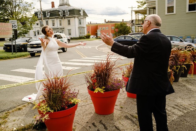 Davina Finn stretching her arms in a hugging motion out on her wedding day. Union Eleven Photographers