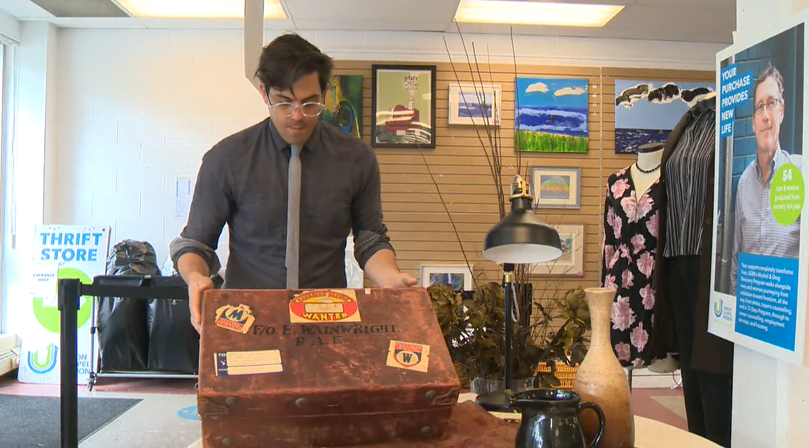 UGM spokesperson Jeremy Hunka displays an old suitcase donated to the charity\’s thrift shop in January.