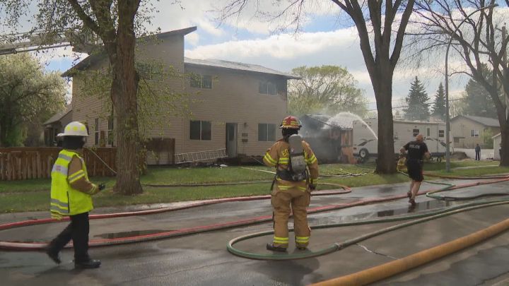 Firefighters at the scene of a fire in Edmonton's Parkdale neighbourhood on Wednesday, May 26, 2021.