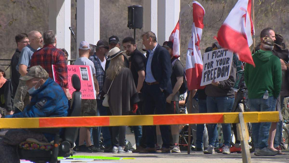 Approximately 100 people attended, flouting public health orders designed to stop the spread of COVID-19. One attendee was carrying a white supremacist flag.