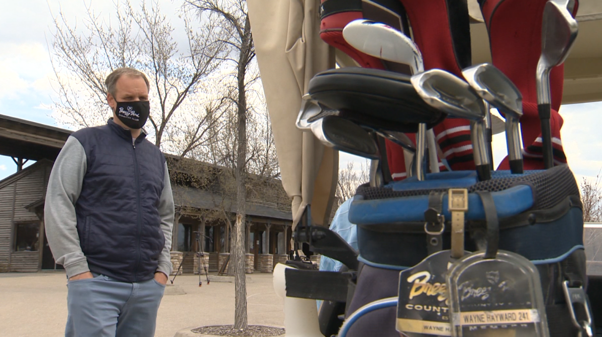 Cory Johnson, the general manager at Breezy Bend country club chatting with a member near the clubhouse.