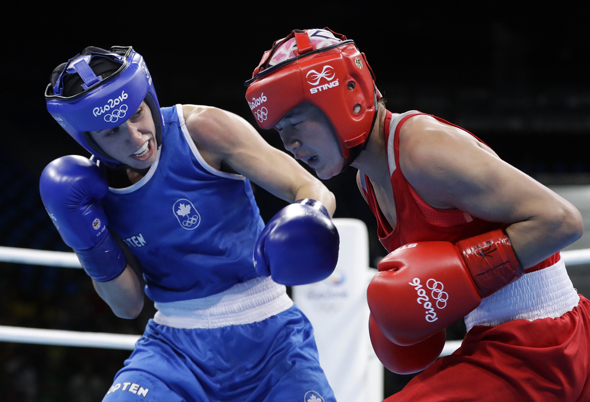 In this Aug. 2, 2016, file photo, Canada’s Mandy Bujold, left, knocks down Uzbekistan’s Yodgoroy Mirzaeva during a women’s flyweight 51-kg preliminary boxing match at the Summer Olympics in Rio de Janeiro, Brazil.
