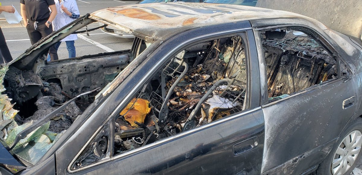A sedan is shown in Rockville, Md., after a cigarette ignited some hand sanitizer and set the vehicle on fire on May 13, 2021.