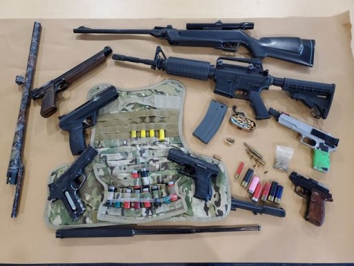 Police say several firearms, replica firearms, and ammunition were among the items seized.