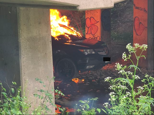 Around 7 p.m. Sunday, a burning vehicle could be seen underneath a bridge on River Road near Veterans Memorial Parkway.