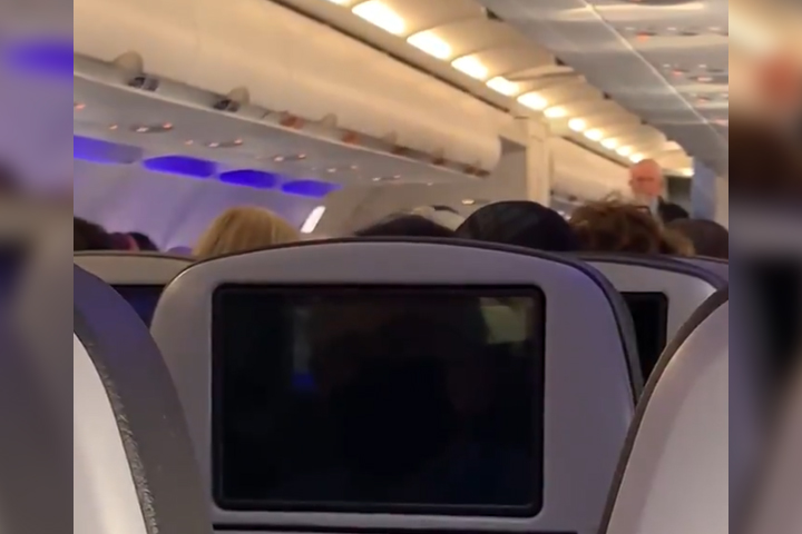 A flight attendant speaks to passengers on a JetBlue flight in this image from video posted May 16, 2021.