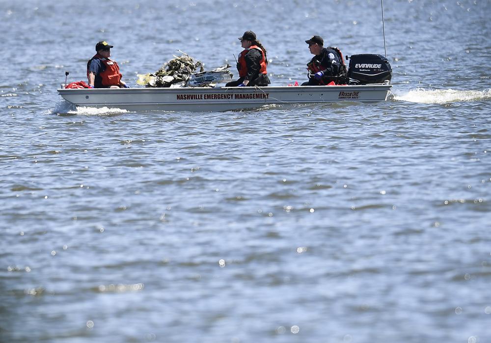 Emergency personnel remove debris from a plane crash in Percy Priest Lake Sunday, May 30, 2021, near Smyrna, Tenn. A small jet carrying seven people crashed Saturday, and authorities indicated that no one on board survived. 