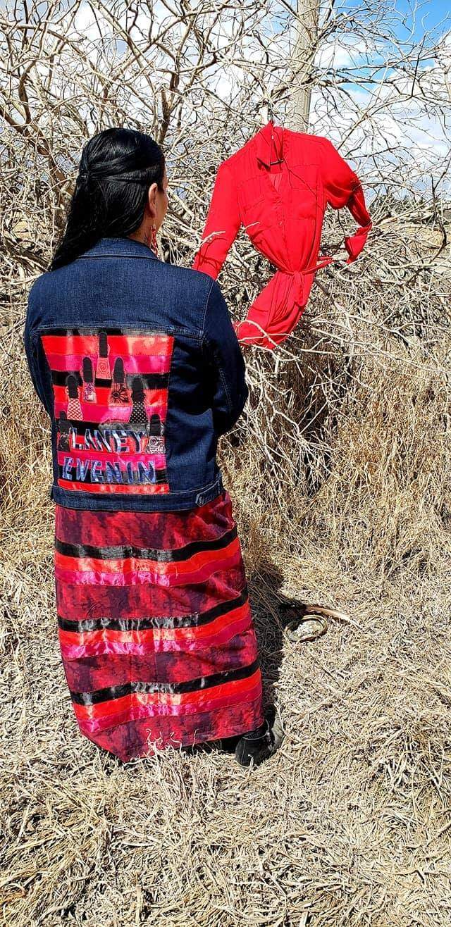Green-Gopher hanging a red dress where her sister Laney’s body was discovered.