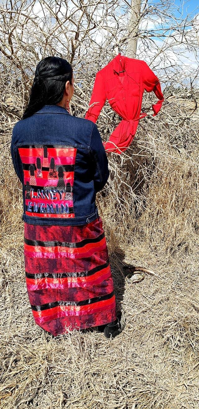 Green-Gopher hanging a red dress where her sister Laney’s body was discovered.