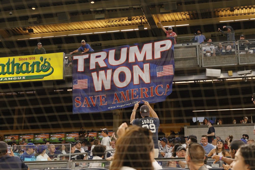 Fans unroll a banner in support of former U.S. President Donald Trump during the fourth inning of Game Two of a doubleheader between the Toronto Blue Jays and the New York Yankees at Yankee Stadium on May 27, 2021 in the Bronx borough of New York City. 