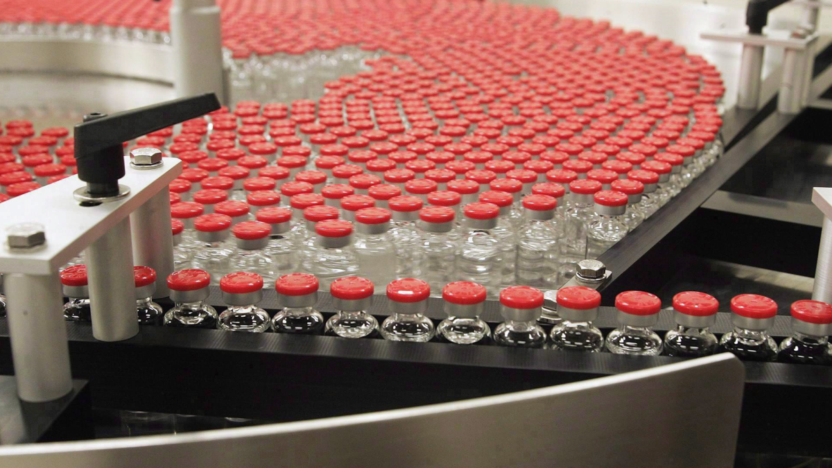 Bottles of flu vaccine rotate on a plate as they make their way through the assembly line at the ID Biomedical Corp. Quebec City plant.