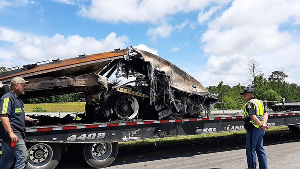 Some of the wreckage from a fatal multiple-vehicle crash a day earlier is loaded to be carried away, Sunday, June 20, 2021, in Butler County, Ala.