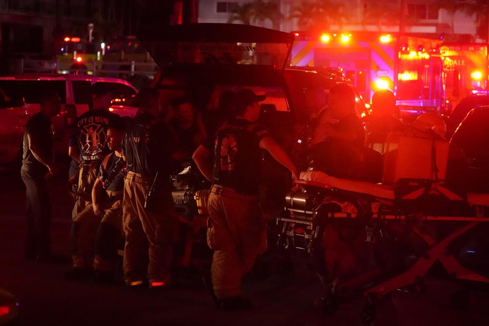 Firefighters standby after a partial collapse of a building, Thursday, June 24, 2021, in the Surfside area of Miami, Fla.