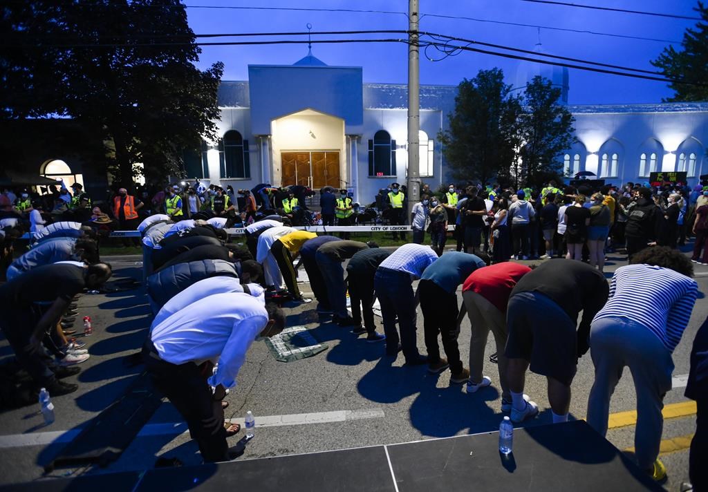 People pray at a vigil outside the London Muslim Mosque for the victims of the deadly vehicle attack on five members of the Canadian Muslim community in London, Ont., on Tuesday, June 8, 2021.THE CANADIAN PRESS/Nathan Denette.