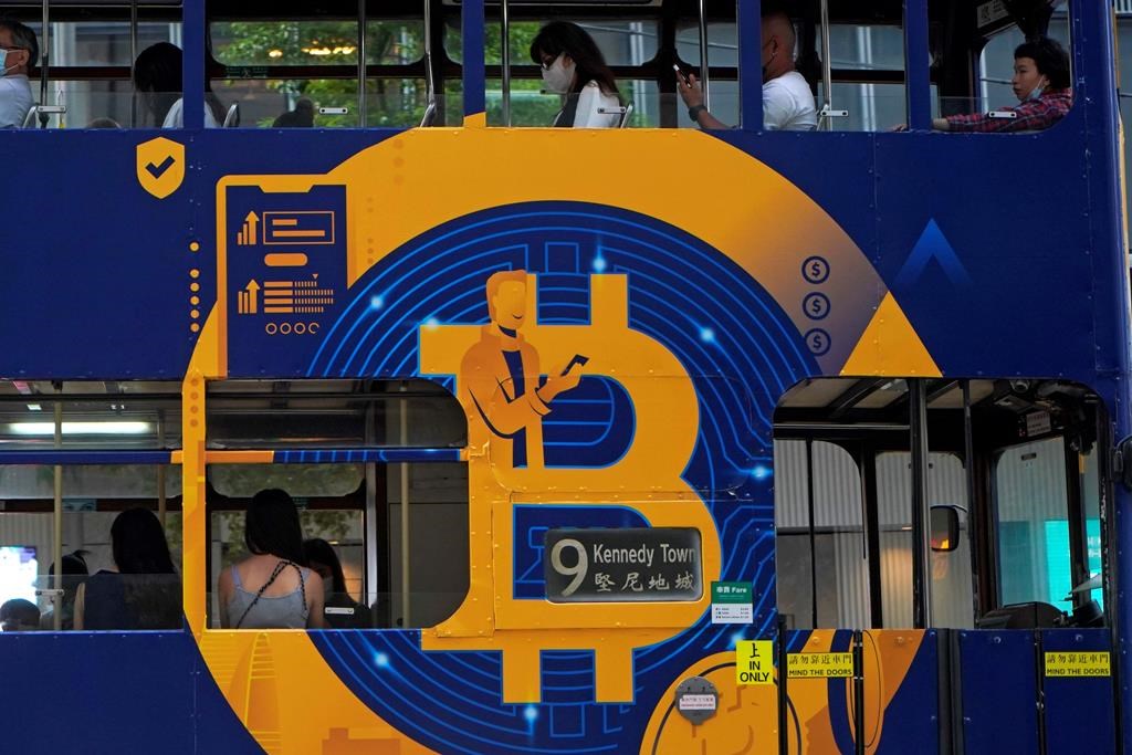 FILE - In this May 12, 2021, file photo, an advertisement of Bitcoin, one of the cryptocurrencies, is displayed on a tram in Hong Kong.