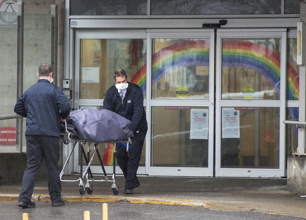 Funeral home workers remove a body from CHSLD Sainte-Dorothée on April 13, 2020, in Laval Que.