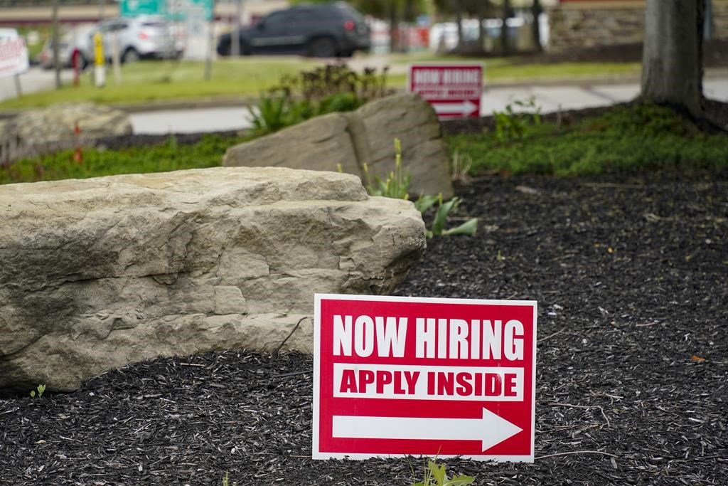 This May 5, 2021 photo shows hiring signs posted outside a gas station in Cranberry Township, Butler County, Pa.