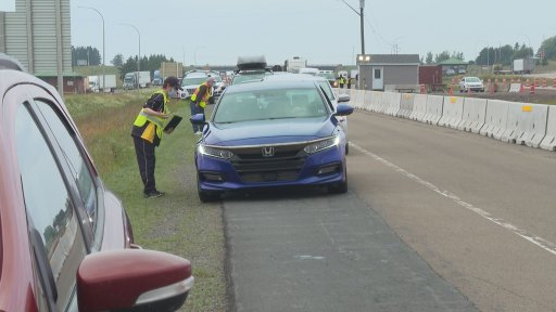 A Nova Scotia border official stops a motorist entering the province at the Trans-Canada Highway land border Wednesday morning